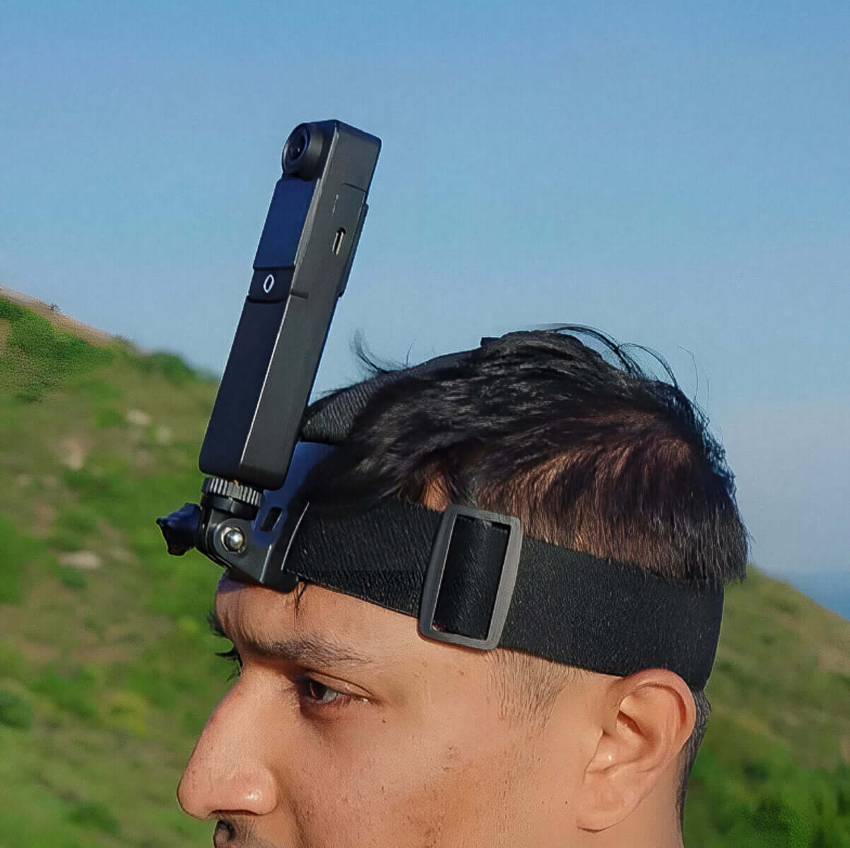 Head Strap worn by a man outdoors, featuring a camera attached for dynamic filming perspectives.
